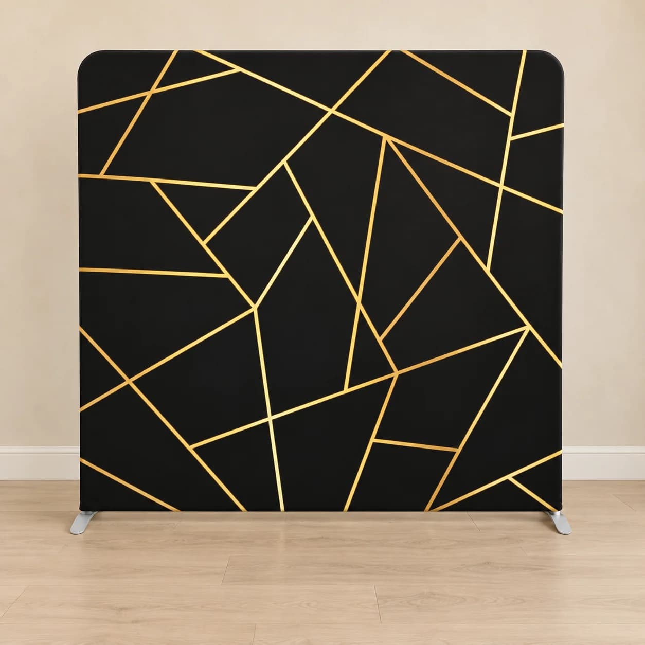 Black fabric backdrop with a gold geometric line print in an illustrative room