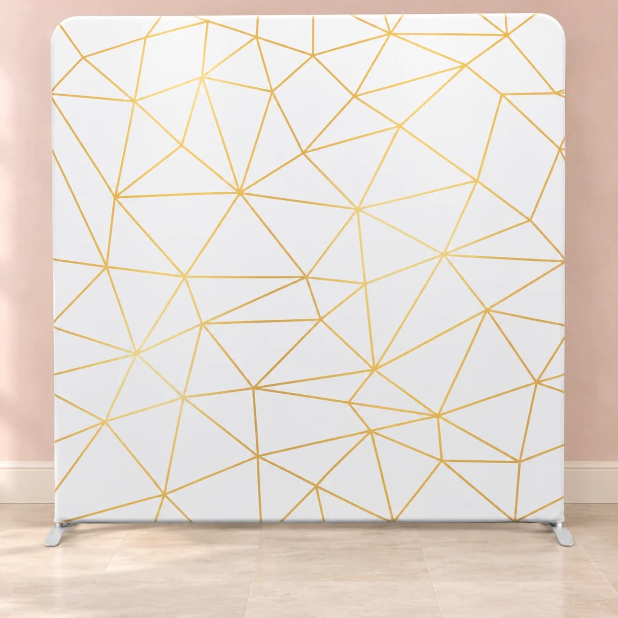 Styled white and gold geometric backdrop in a coordinating room